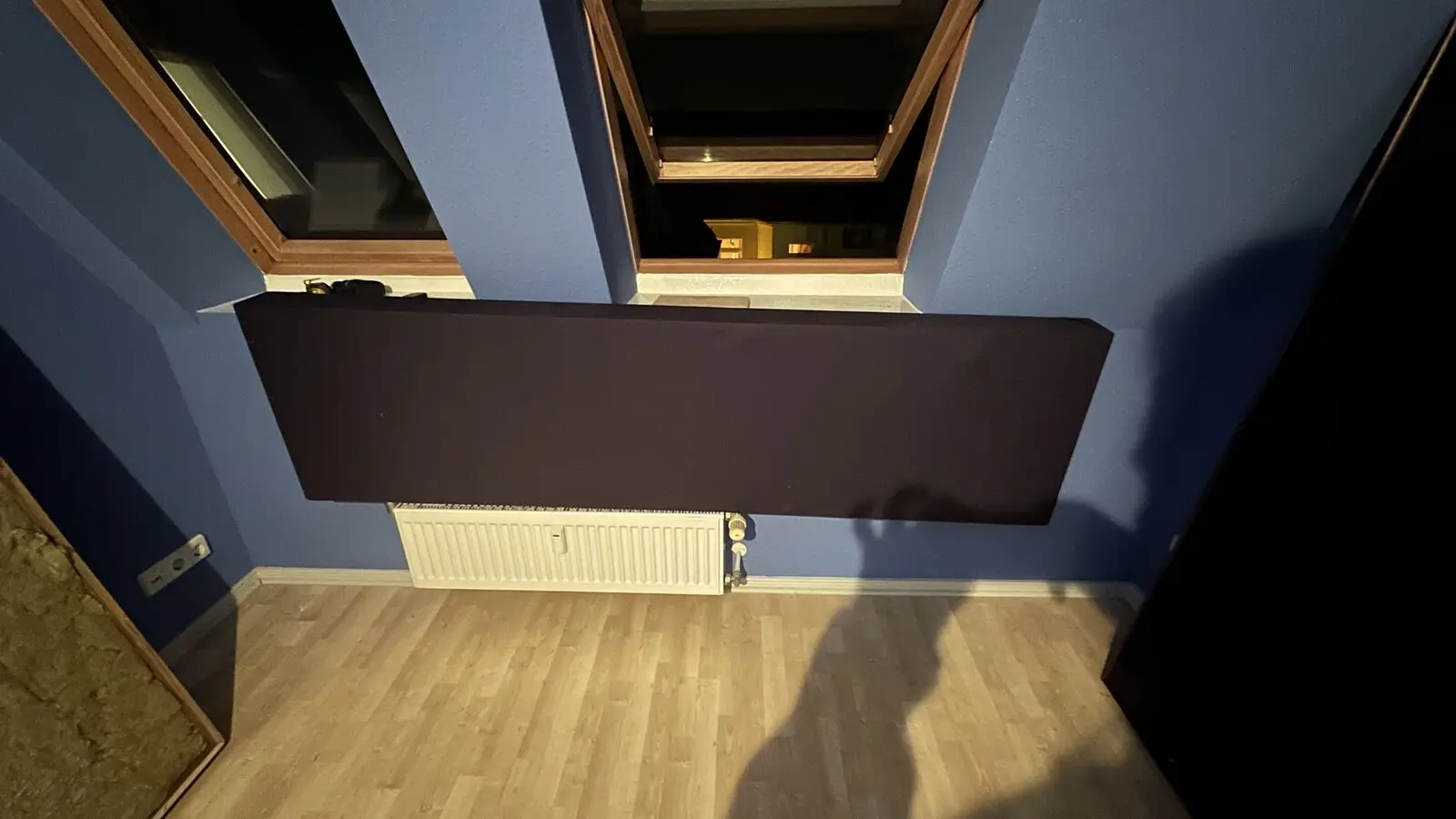 Black absorber under a blue sloped ceiling
