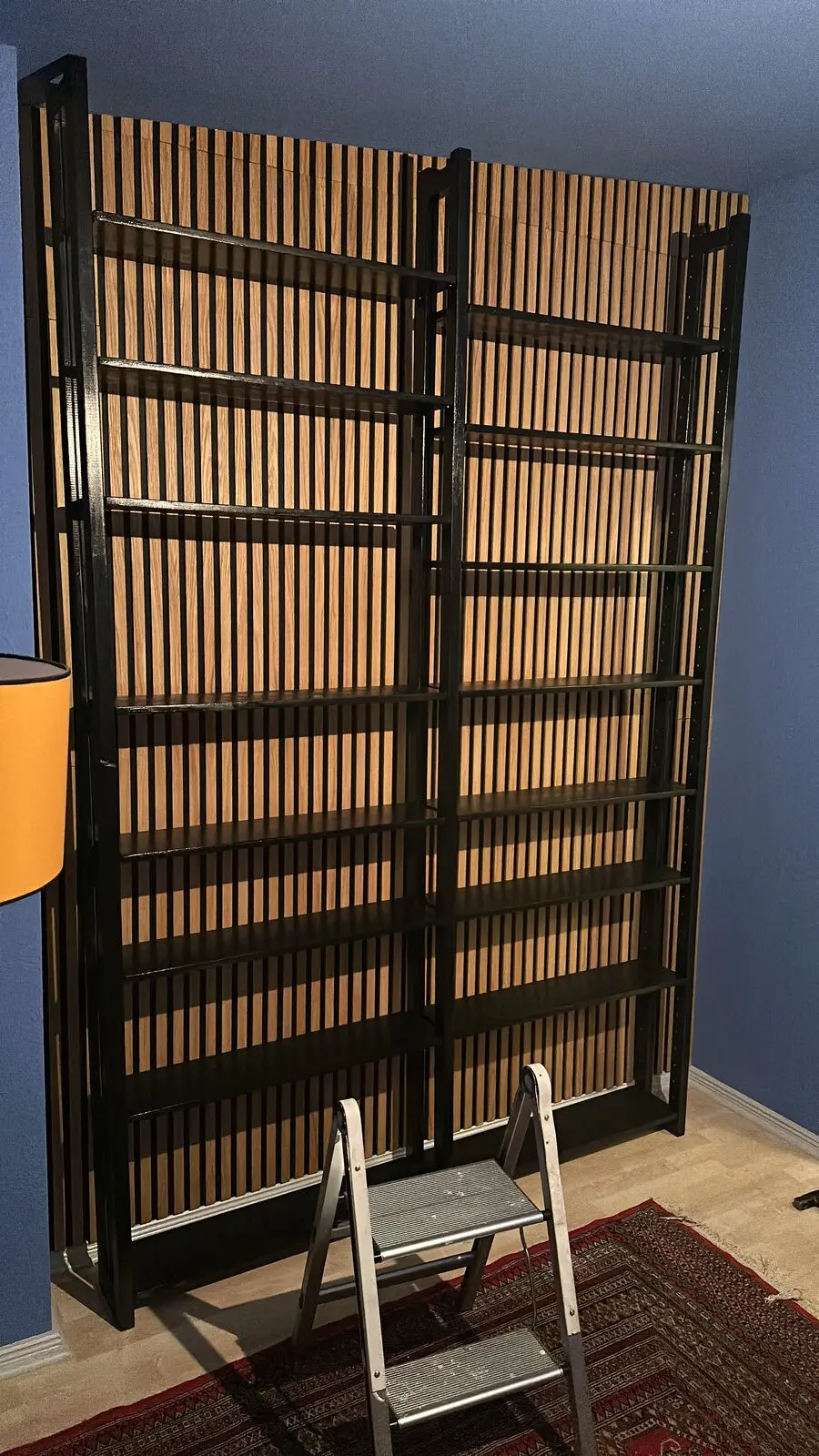 The finished slatted wall with shelves, still empty