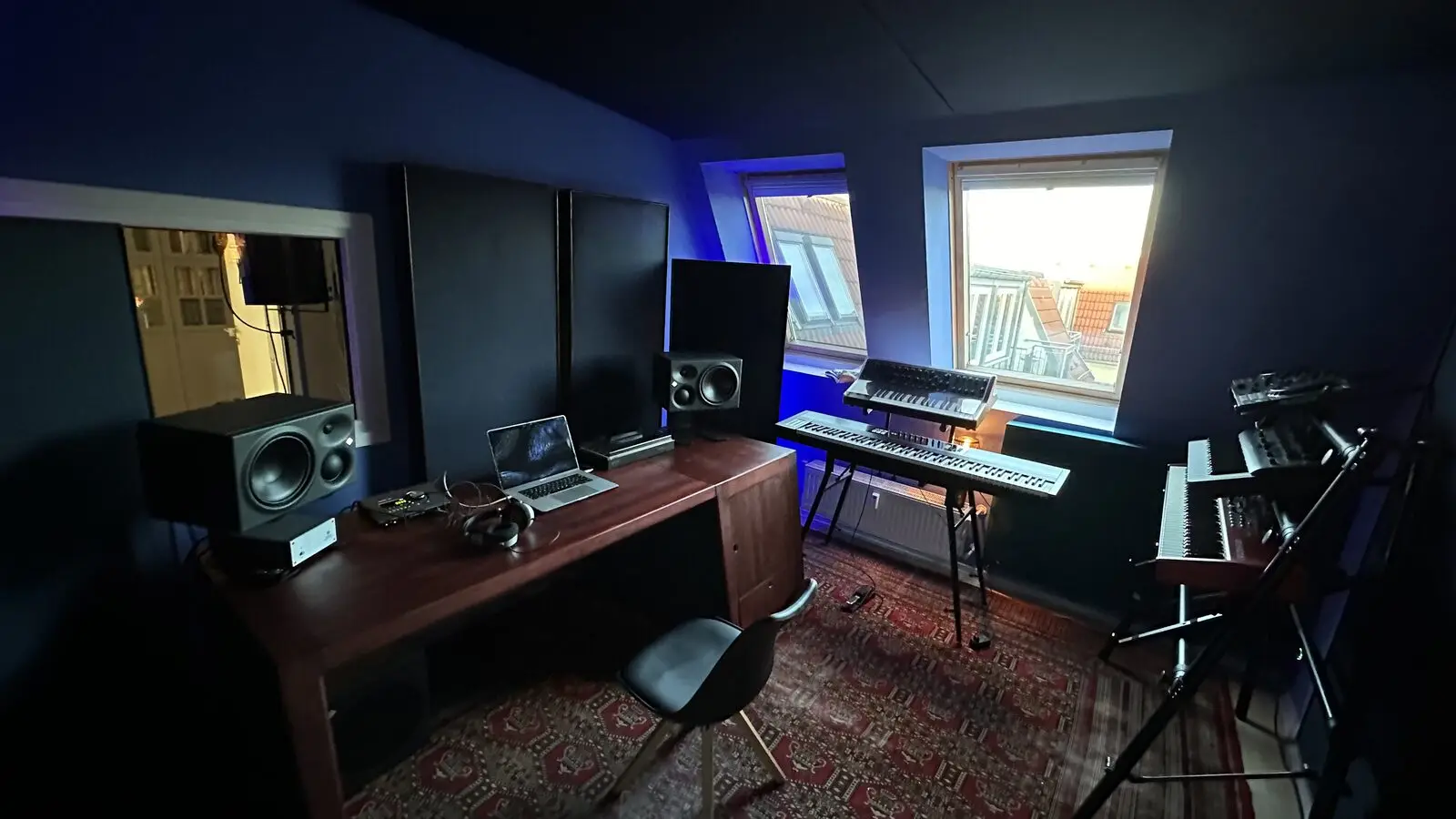 The control room at night: desk, monitors, keyboard and window