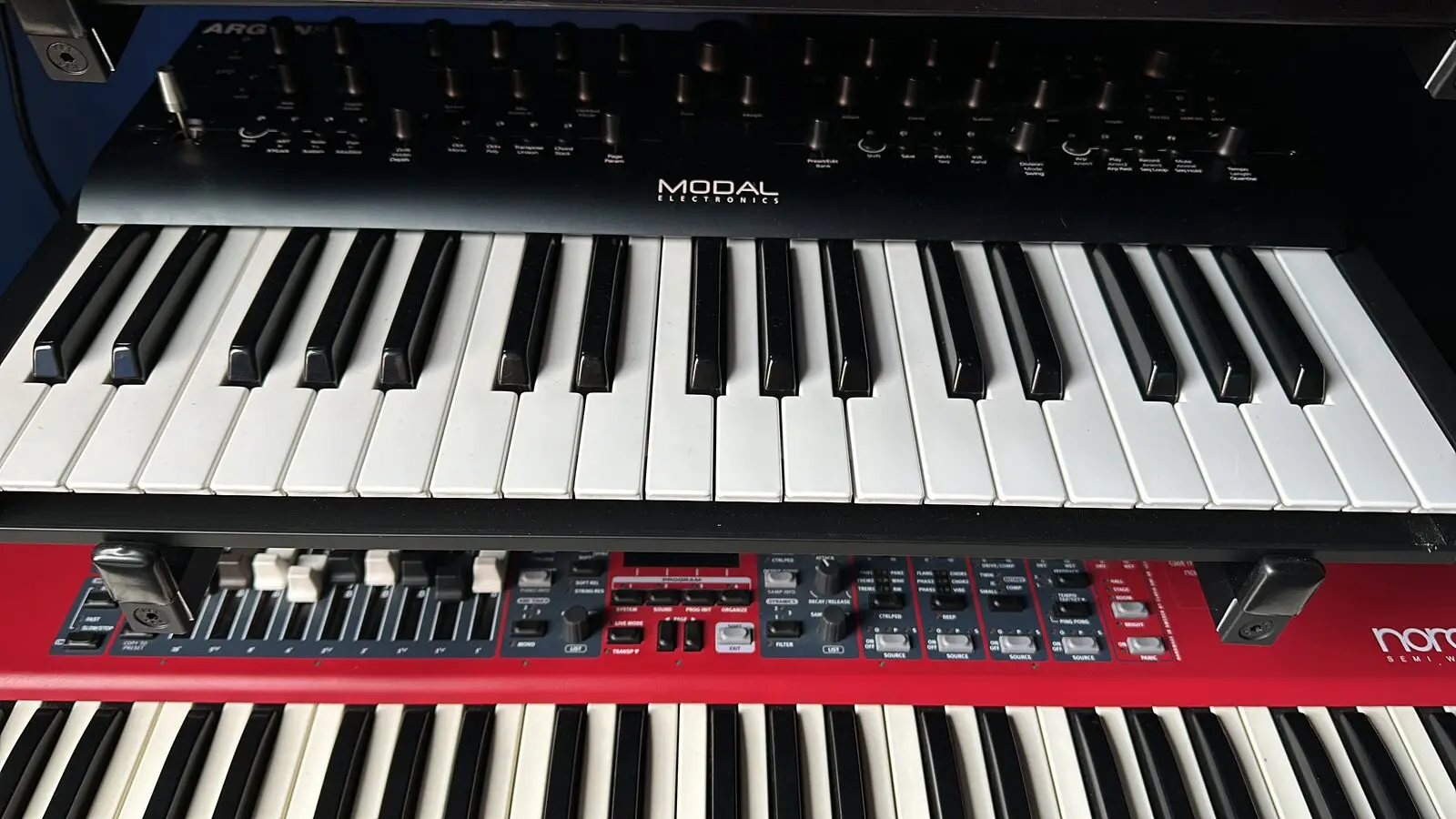 Two keyboards stacked on a stand