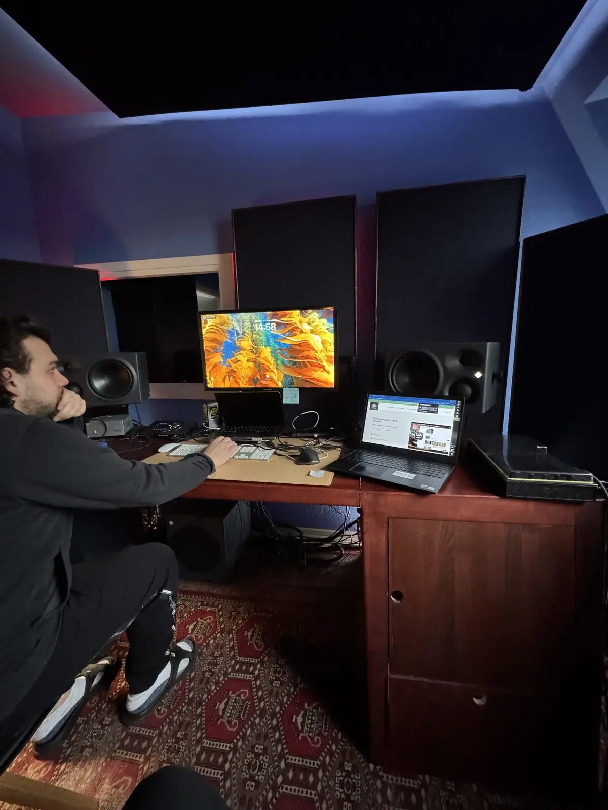 A person at the desk, a colourful picture on the screen