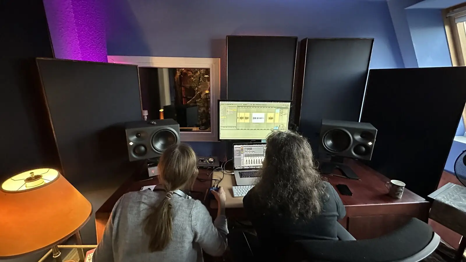 Recording a commercial: Yura at the desk on the right, Anna from the recording team on the left
